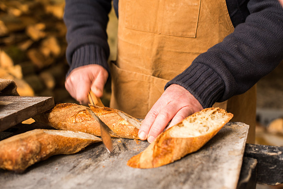 Baker slicing a baguette